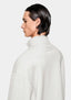 Side profile of the Oatmeal Quarter Zip showing the funnel neck and tonal logo below the collar