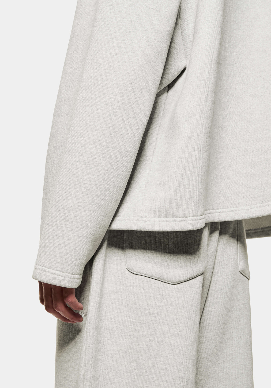 Close-up of the open cuff and hem on the Oatmeal Superweight Quarter Zip