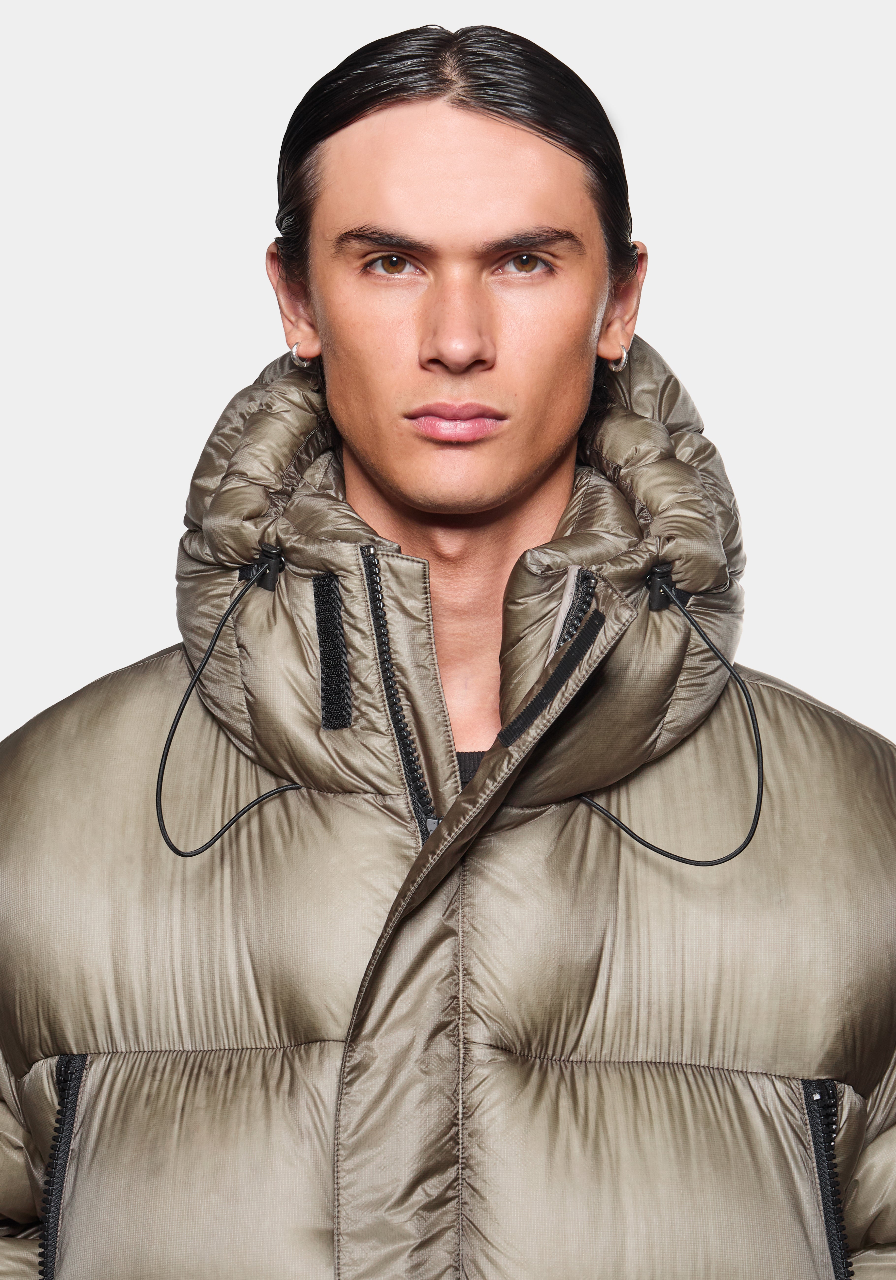 Close-up profile view of the hood up on the Apex Down Parka in Moss