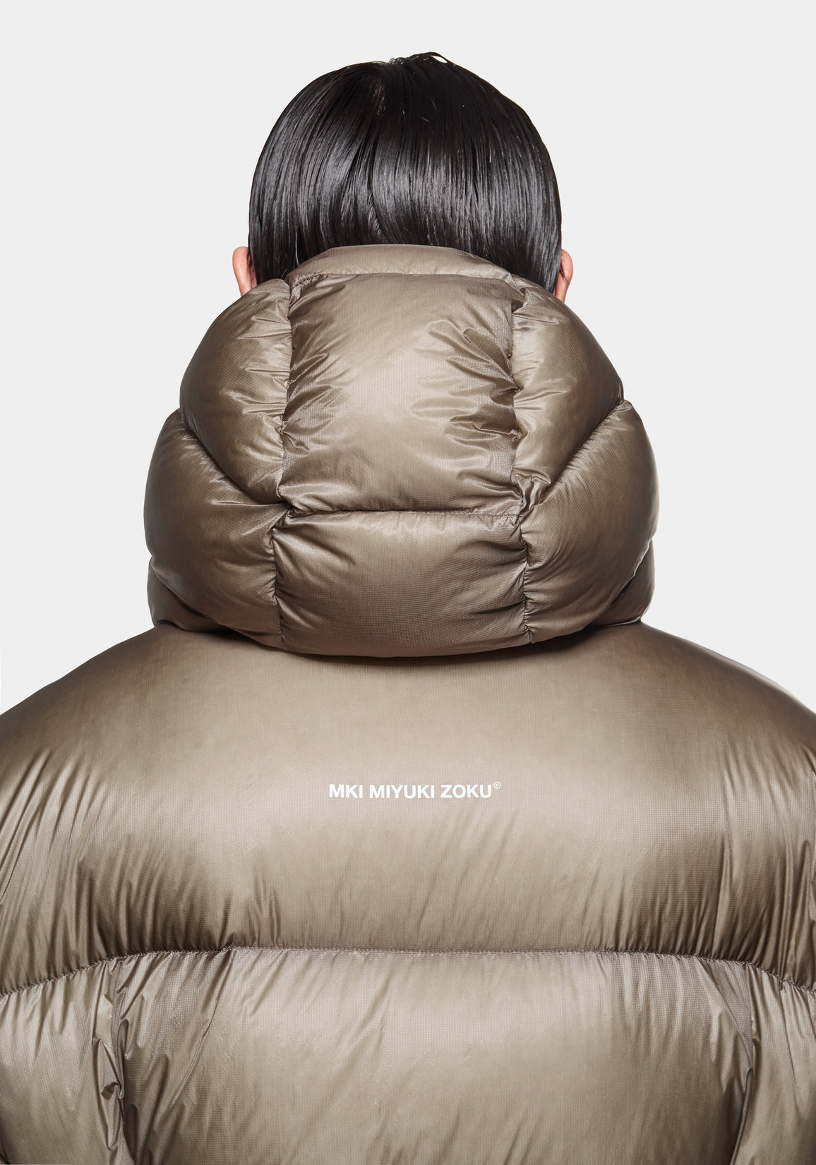 Close-up of the ripstop nylon fabric and cuff on the Apex Down Parka in Moss