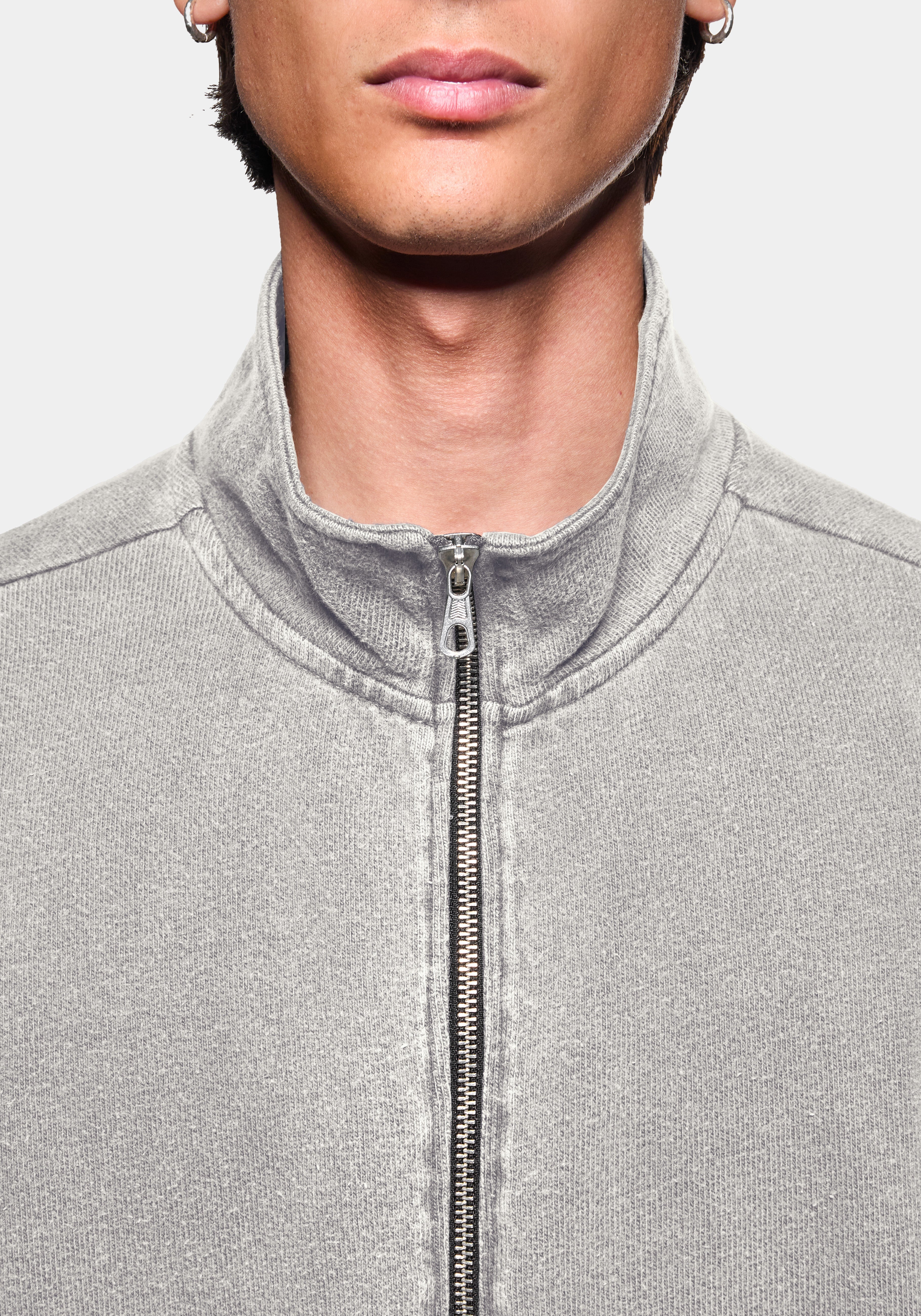 Close-up of the zip funnel neck on the track jacket