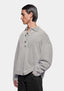 Front view showing the three button placket, styled with black trousers