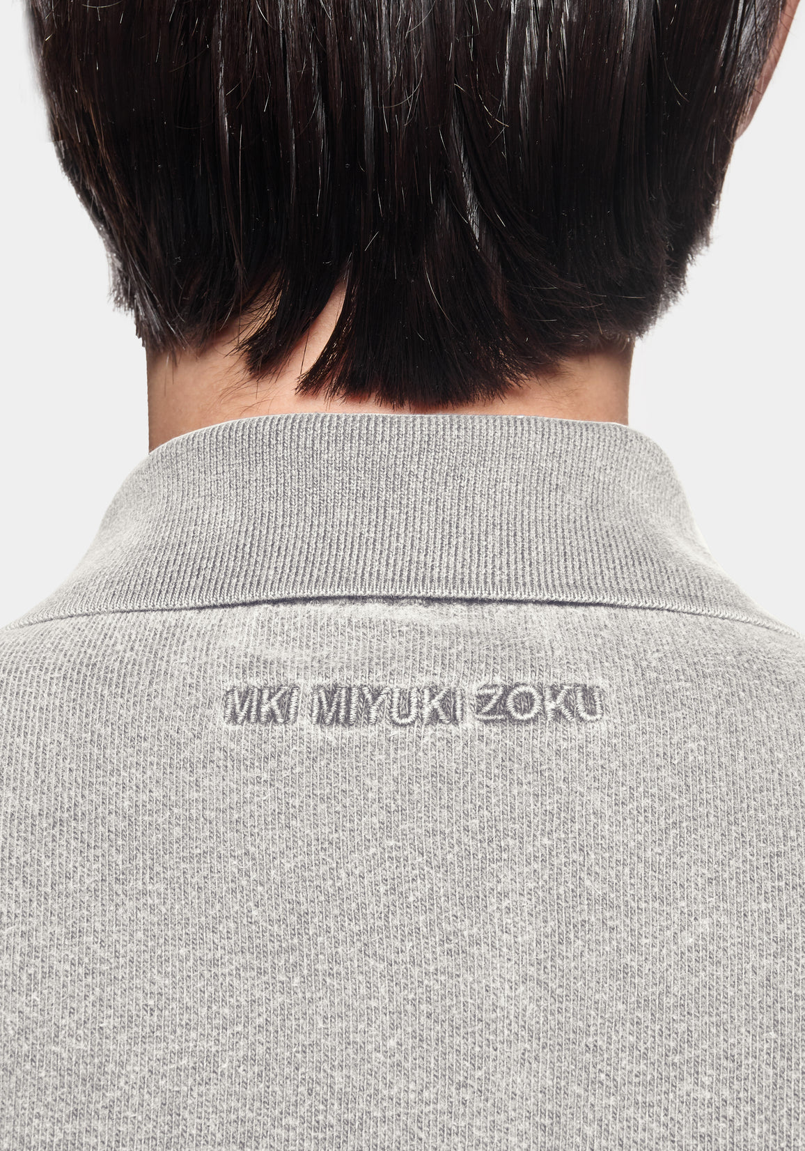 Back view showing the ribbed collar and MKI MIYUKI ZOKU embroidery