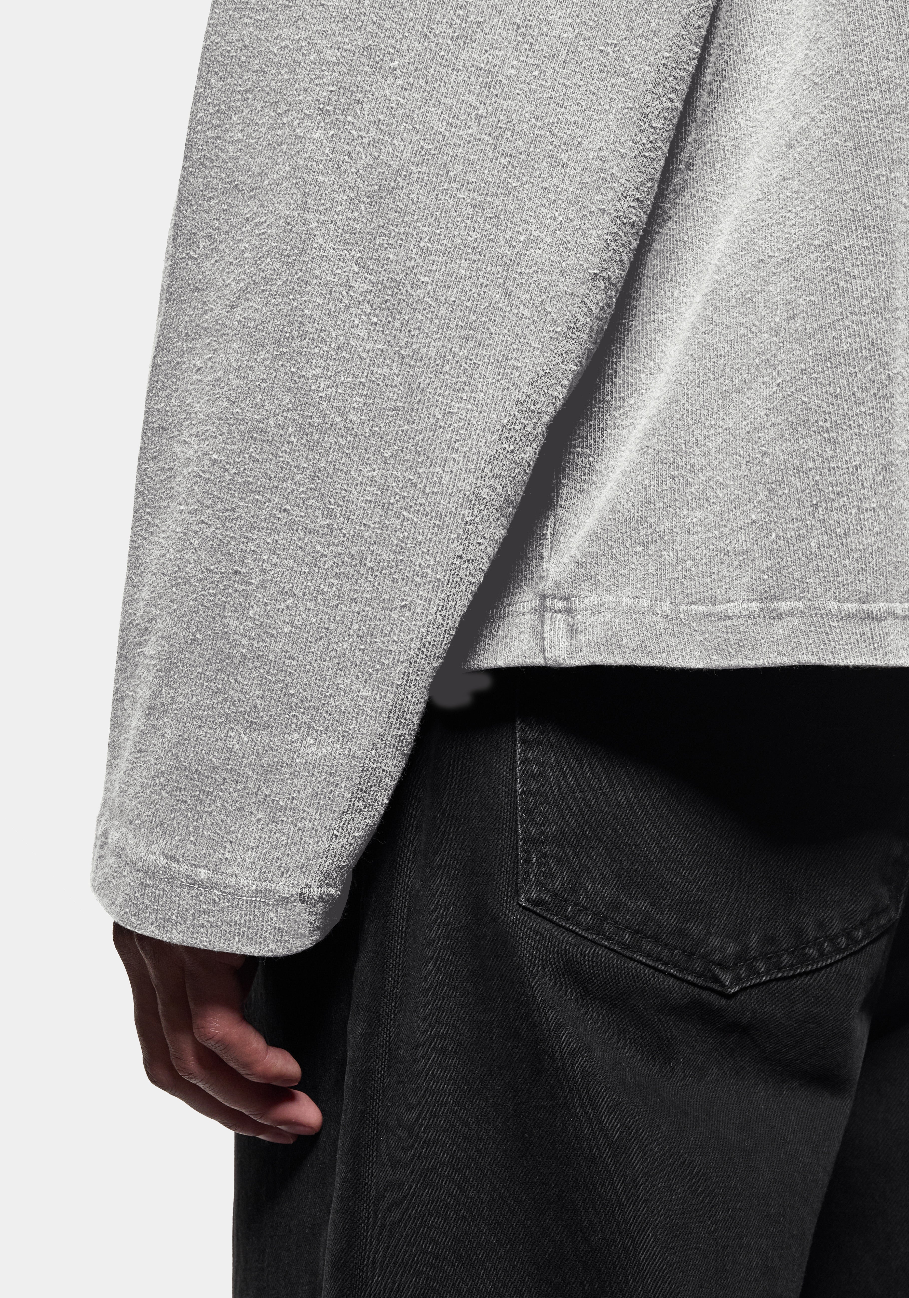 Close-up of the textured knit, worn with black denim jeans