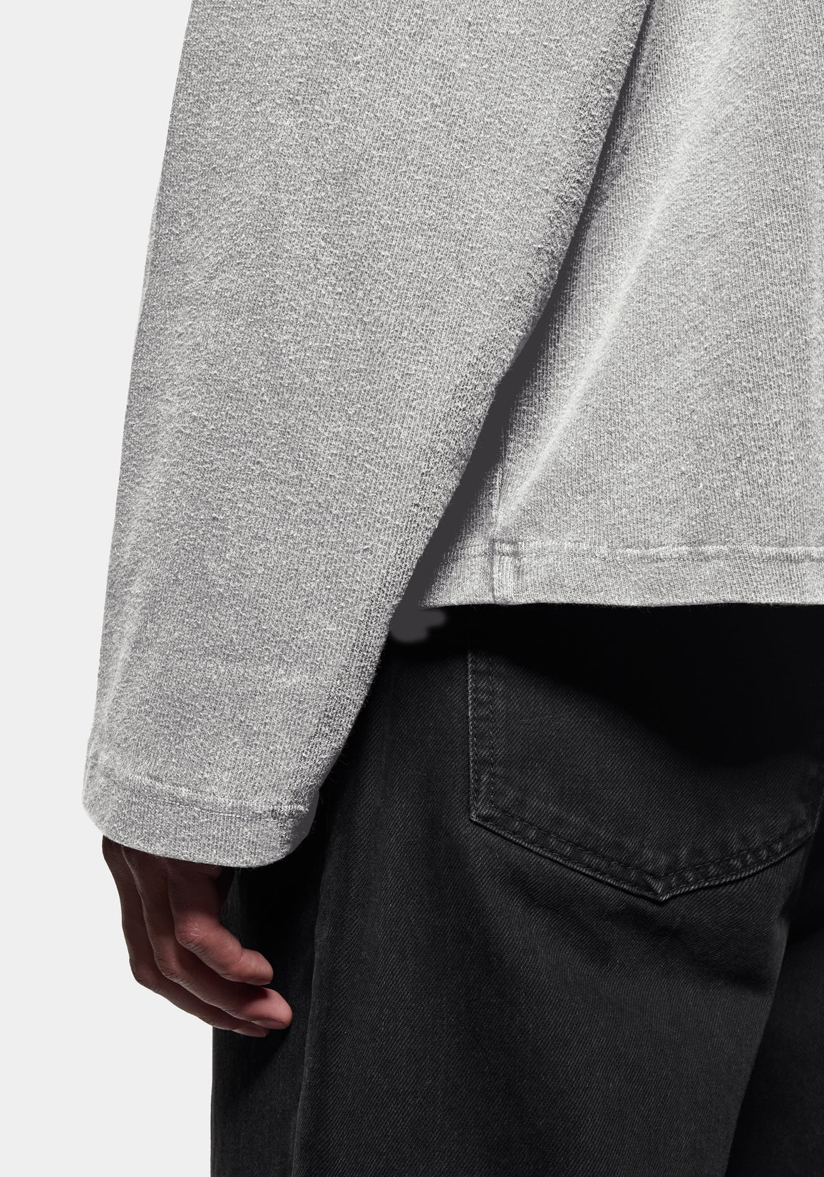 Close-up of the textured knit, worn with black denim jeans