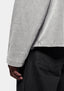 Close-up of the textured knit, worn with black denim jeans