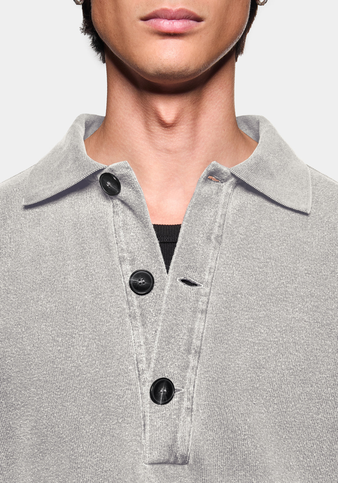Close-up of the knitted texture and black buttons