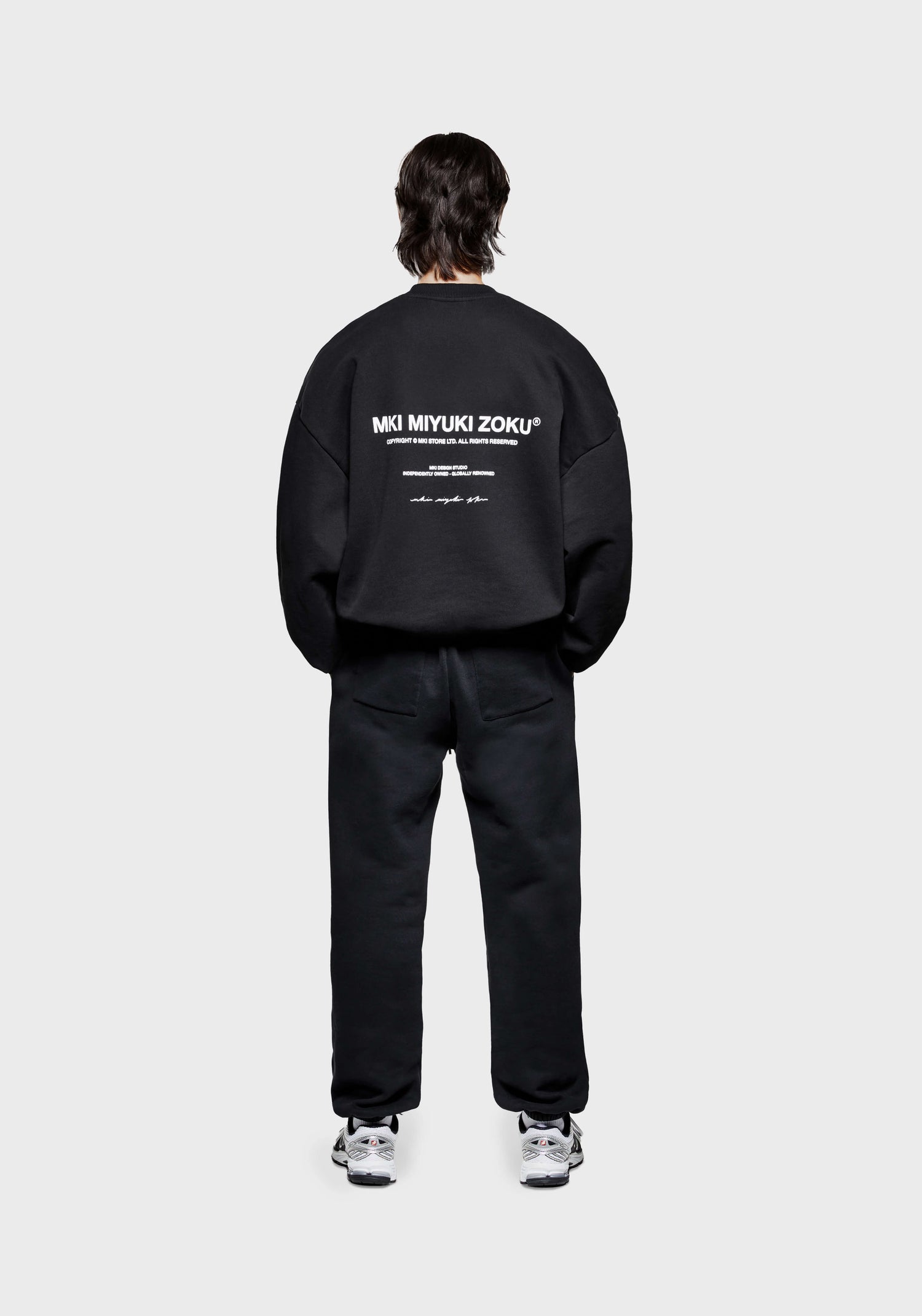 Full back view of the men's MKI Design Studio crew neck pull over sweatshirt in a black colour in a boxy fit