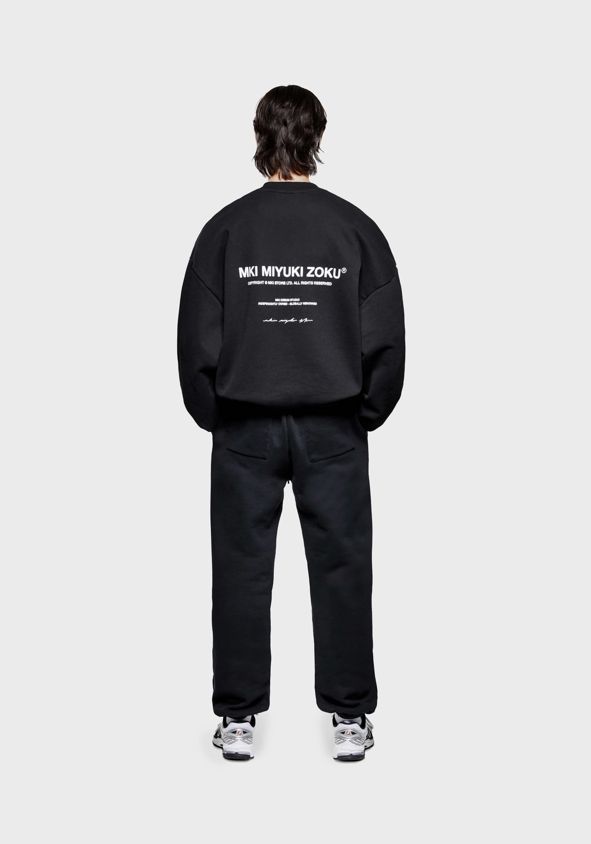 Full back view of the MKI MIYUKI ZOKU Design Studio Crewneck in Black, in an oversized box fit