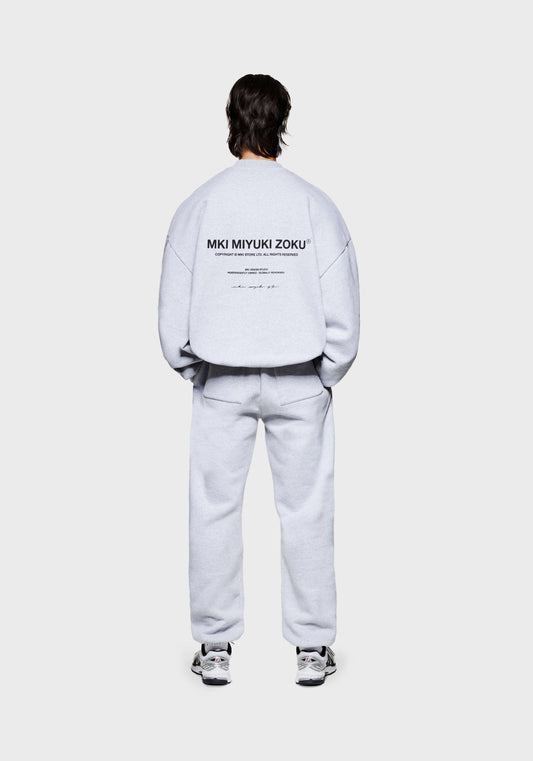 Full back view of the men's MKI Design Studio crew neck pull over sweatshirt in a grey colour in a boxy fit