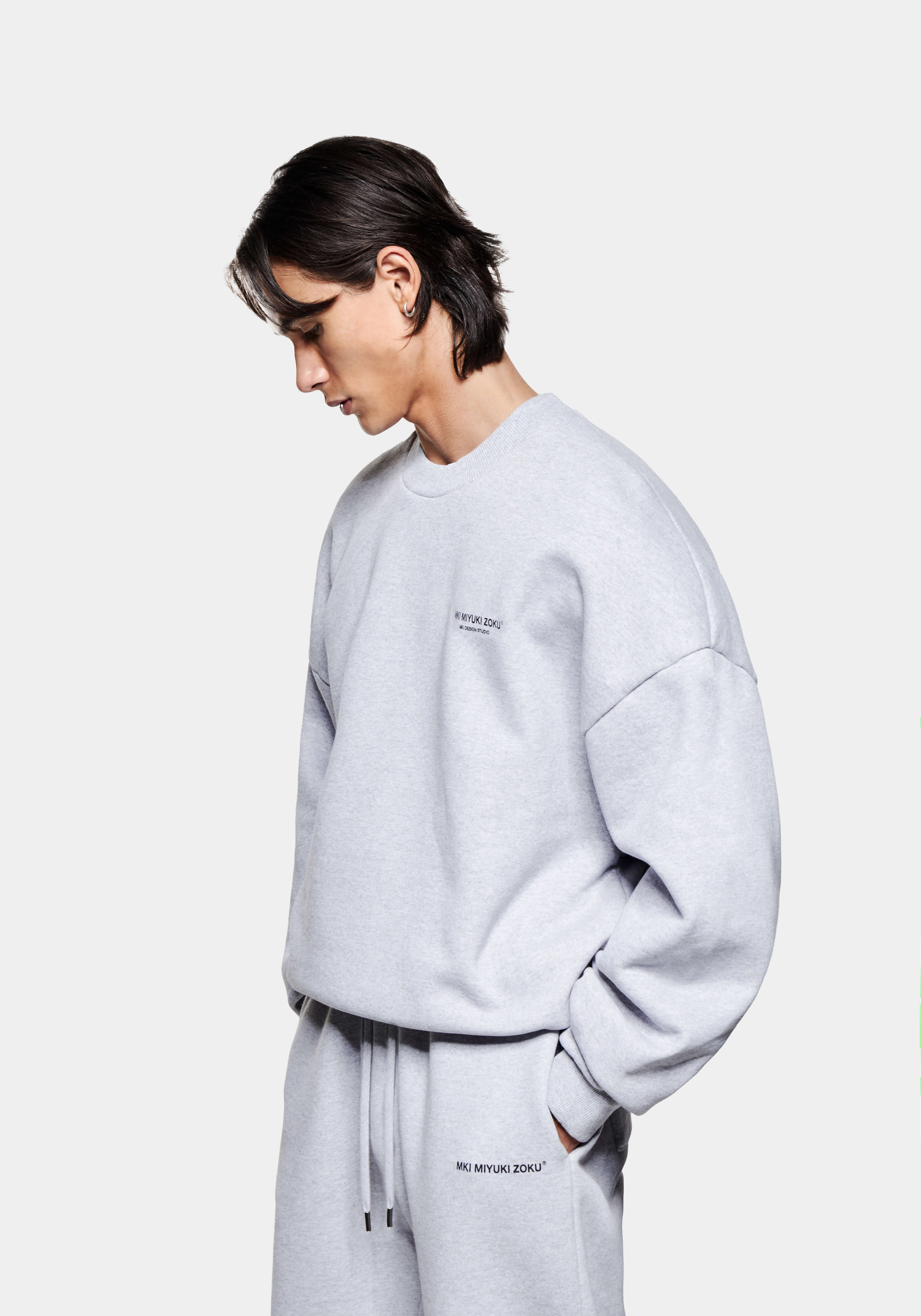 Front side view of the Design Studio Crewneck in Grey