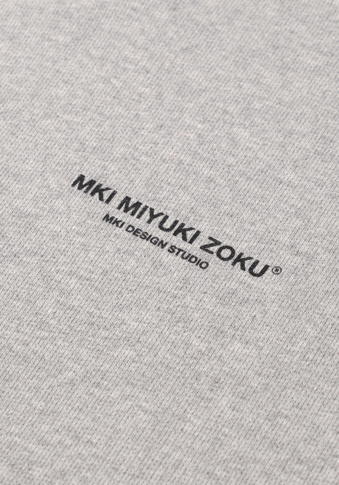 Flat close-up of the black graphic print on the Design Studio Crewneck in Grey