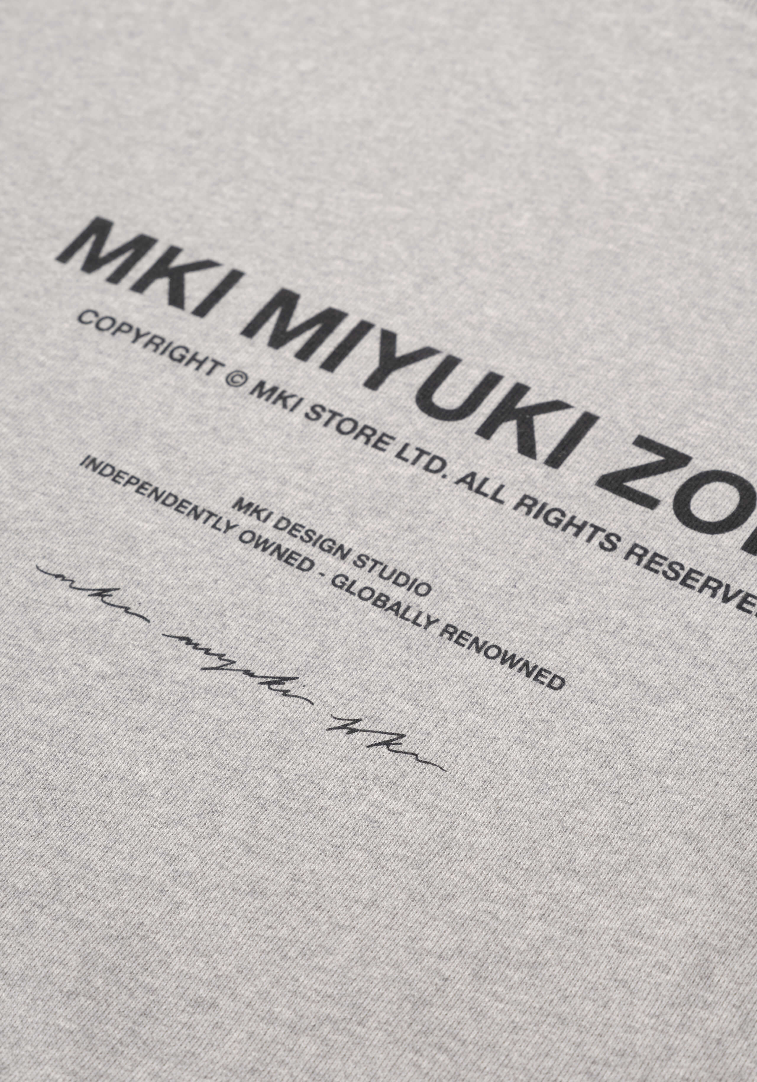 Flat close-up of the printed rear branding on the Design Studio Crewneck in Grey