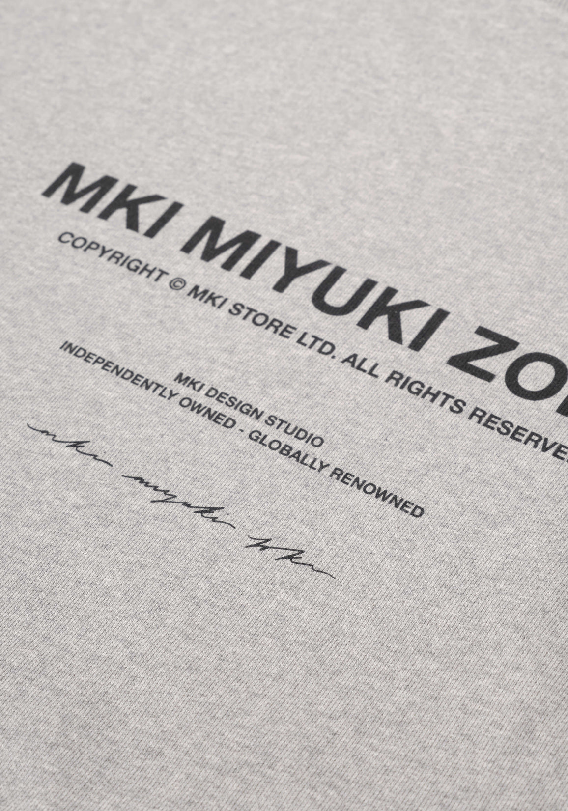Flat close-up of the printed rear branding on the Design Studio Crewneck in Grey
