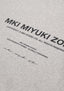 Flat close-up of the printed rear branding on the Design Studio Crewneck in Grey