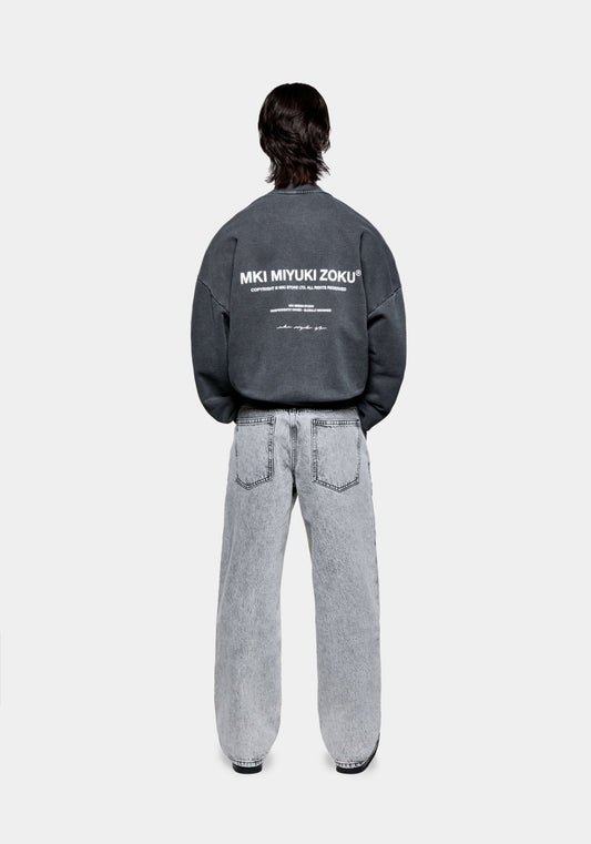 Full back view of the men's MKI Design Studio crew neck pull over sweatshirt in a pigment black colour in a boxy fit