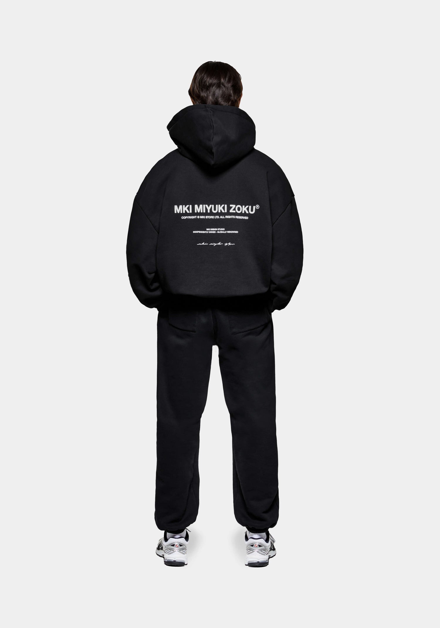 Rear view of the MKI 500gsm boxy fit heavyweight Design Studio hoodie for men in a core black colourway