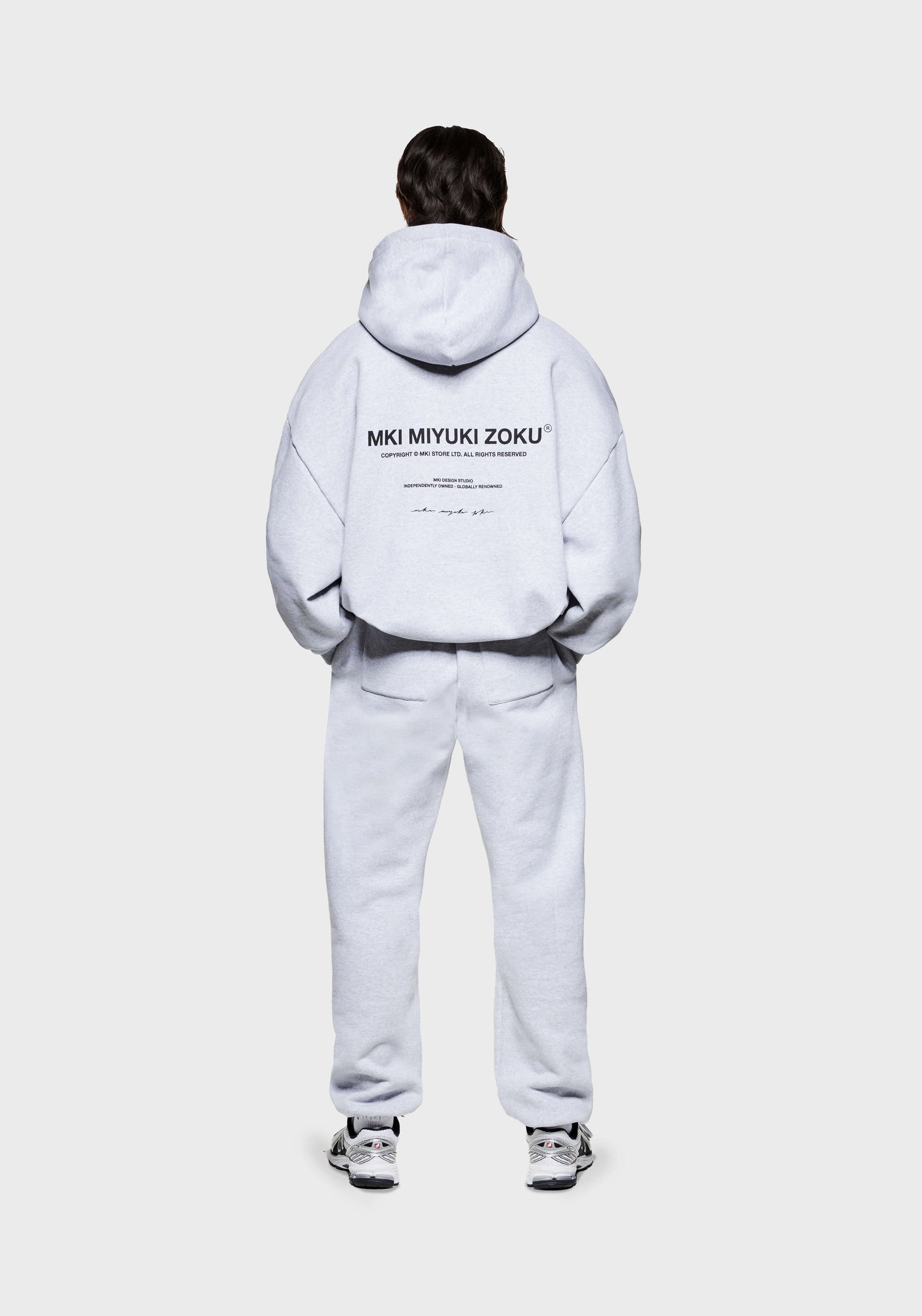 Rear view of the MKI 500gsm boxy fit heavyweight Design Studio hoodie for men in a grey colourway