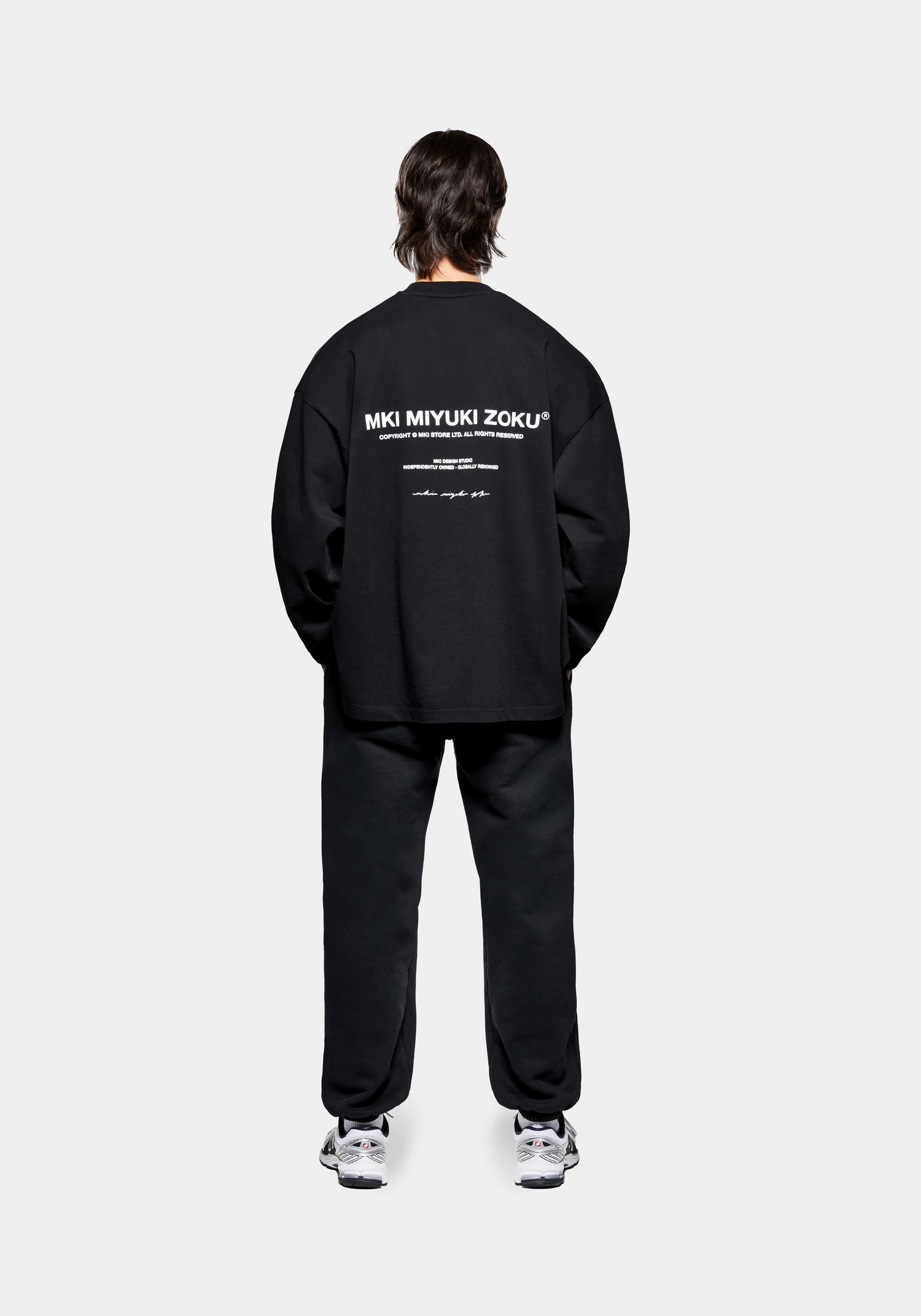 Full back view of the MKI Design Studio long sleeve oversized t-shirt in a black colour in a boxy fit