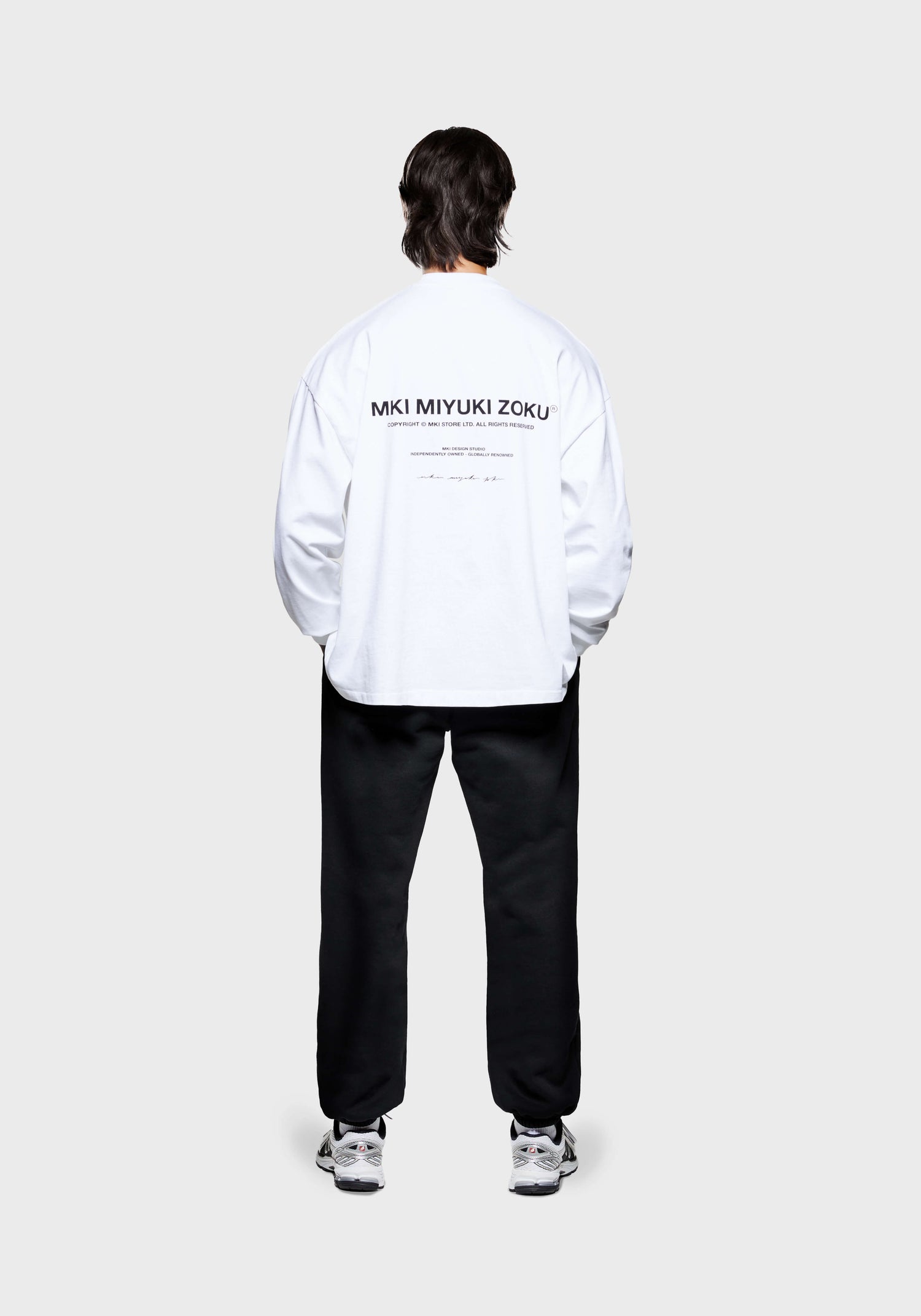 Full back view of the MKI Design Studio long sleeve oversized t-shirt in a white colourway in a boxy fit