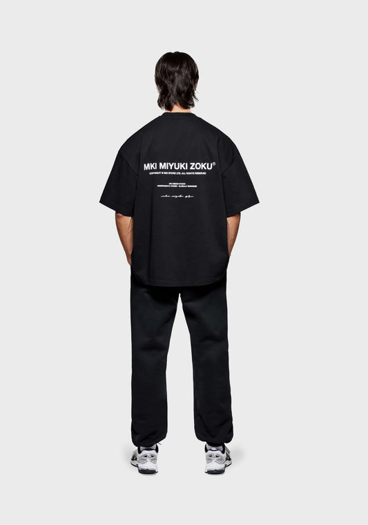 Full rear view of the MKI Design Studio T-Shirt in Black with contrasting white graphic branding