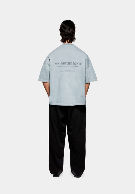 Full rear view of the MKI Design Studio oversized graphic t-shirt in a treated pigment-washed glacier blue colour