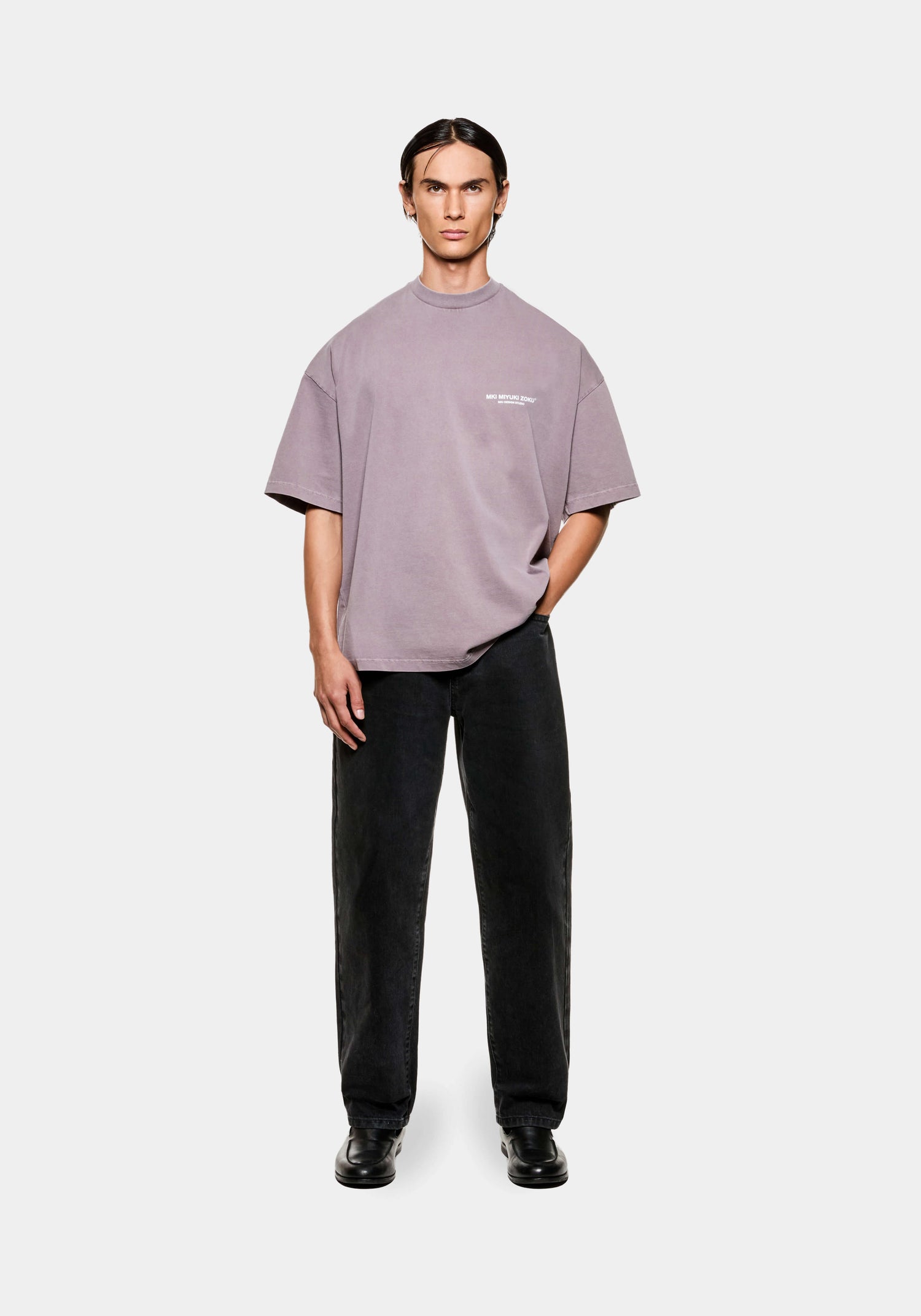 Full front view of a men's oversized MKI Design Studio T-shirt in a washed pigment raisin colourway with design studio branding at the chest
