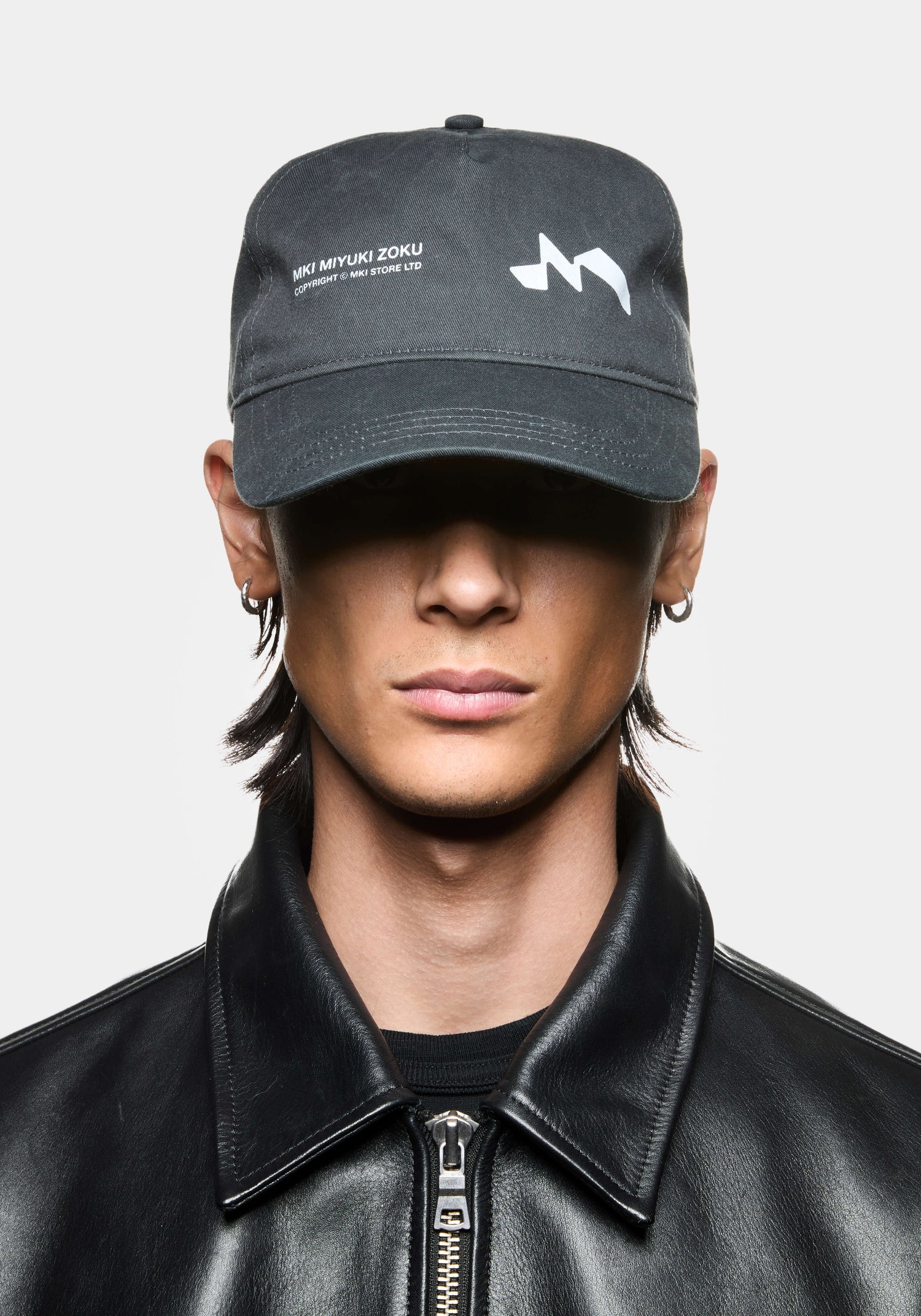 Pigment black MKI Silhouette Cap featuring MKI Miyuki Zoku branding and snapback adjuster.