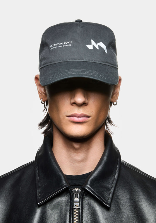 Pigment black MKI Silhouette Cap featuring MKI Miyuki Zoku branding and snapback adjuster.