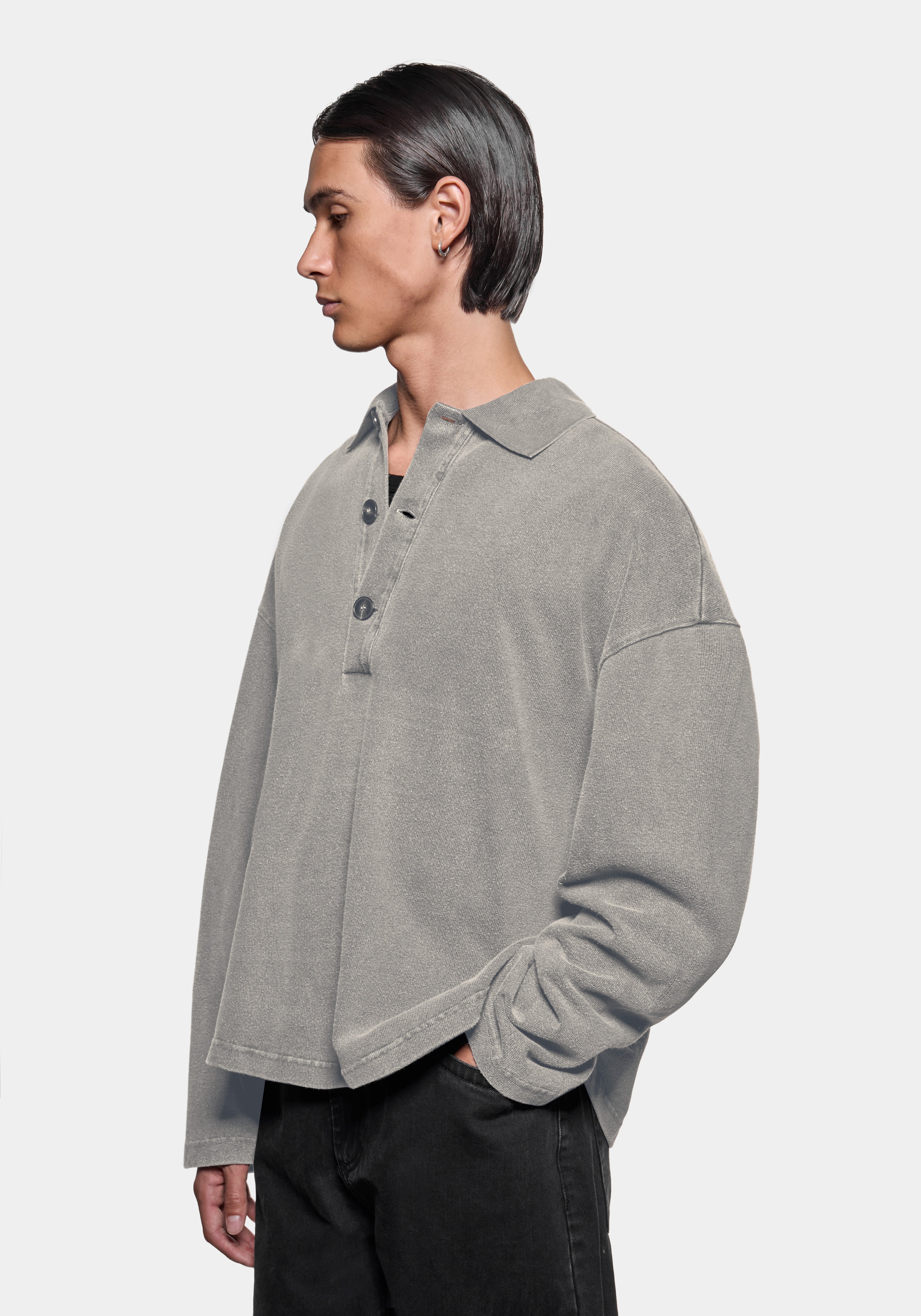 Front three-quarter view showing the ribbed rugby collar and three button placket