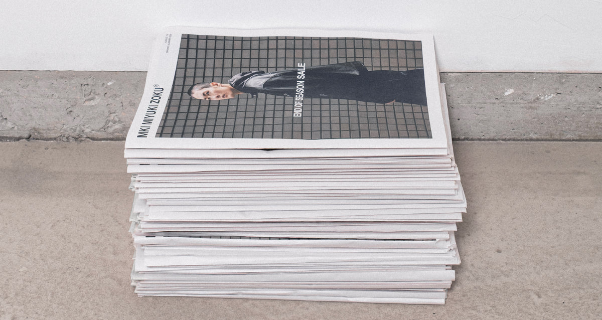 Stack of MKI Miyuki Zoku promotional newspapers on a concrete floor