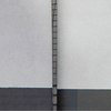 Vertical brick column dividing two grey wall surfaces